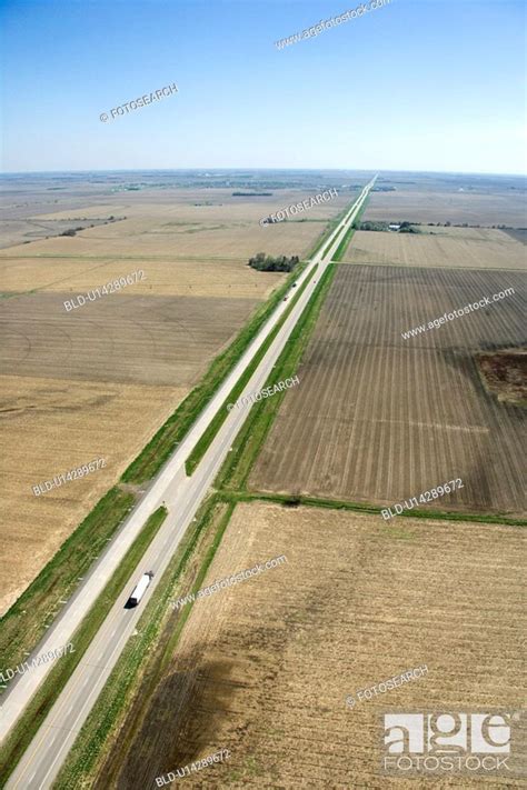 Aerial View Of Highway Through Rural Farmland With Crops Stock Photo