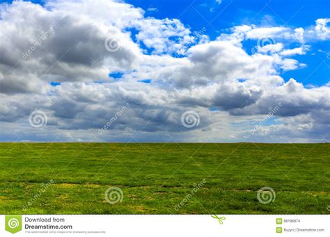 Realistic Blue Cloudy Sky With Bright Sun Over Green Meadow Field Stock