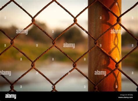Rusty Wire Fence Cyclone Fencing In Repeating Patterns Stock Photo