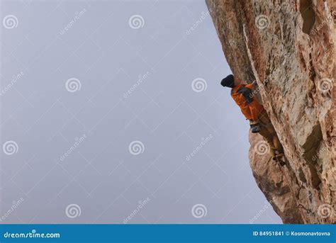 Outdoor Sport Rock Climber Ascending A Challenging Cliff Extreme