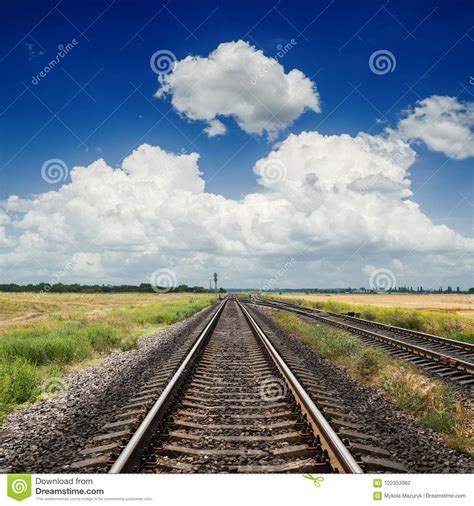 Railroad To Horizon In Blue Sky With Clouds Stock Photo Image Of