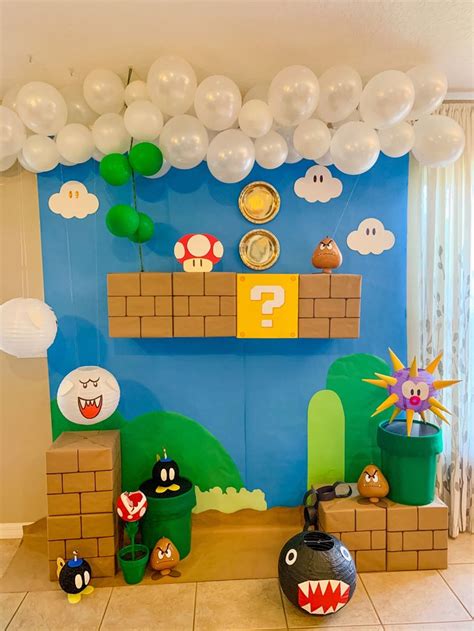 A Nintendo Themed Birthday Party With Balloons And Paper Marios House