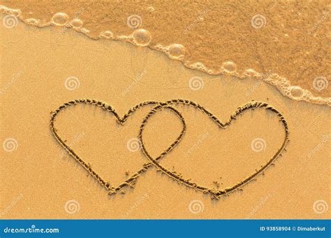 Two Hearts Drawn On Sand Of A Tropical Beach At Sunset Royalty Free