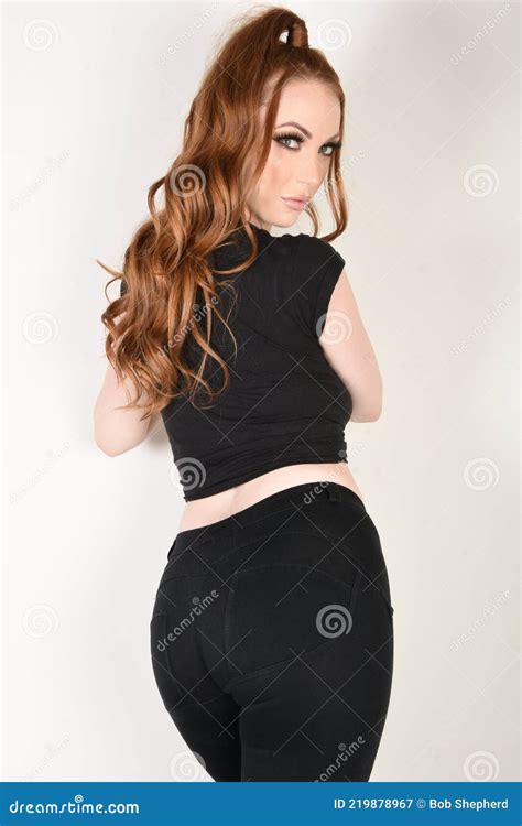 Beautiful Tall Slim Redhead Model In A Fashionable T Shirt And Black