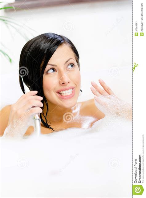 woman lying in bathtub plays with shower head stock image image of beautiful bath 37344283