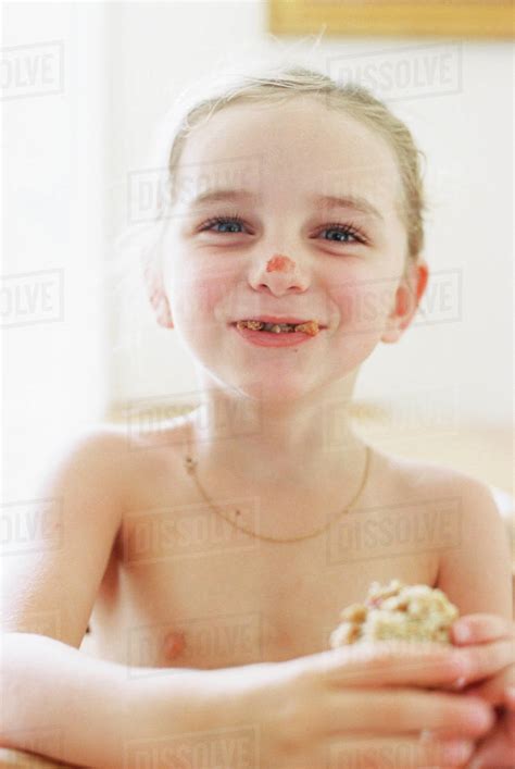 Nude Young Girl Eating A Sandwich With Crumbs In Her Mouth And Tomato