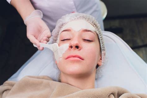 Beautiful Woman Having A Facial Cosmetic Scrub Treatment From