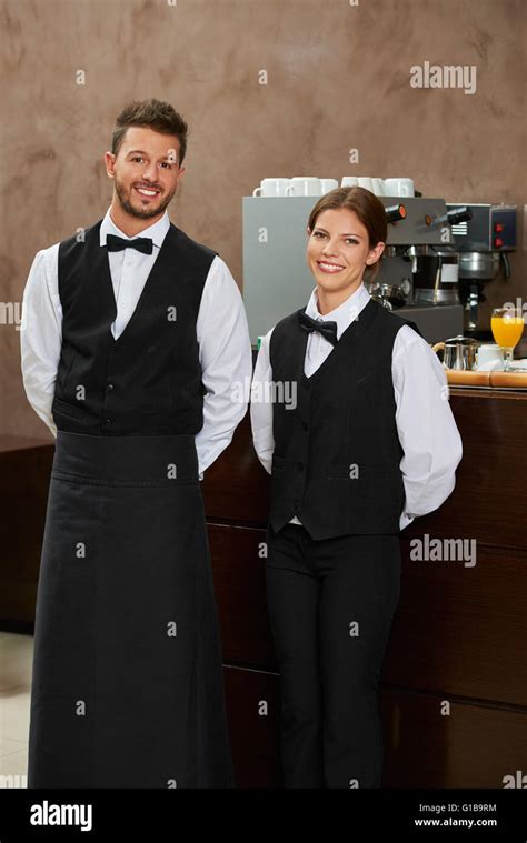 Smiling Waiter And Waitress In Uniform In A Restaurant Stock Photo Alamy