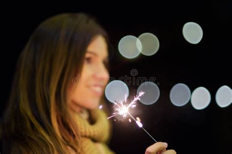 Beautiful Woman Having Fun With Sparkler In Her Hands Celebrating New