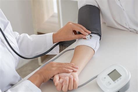 Doctor Evaluates The Patient With A Stethoscope Blood Pressure Monitor