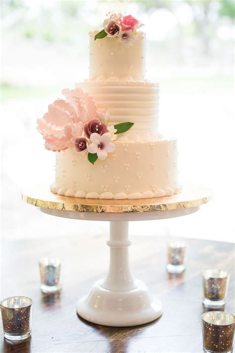 white buttercream wedding cake with sugar flowers
