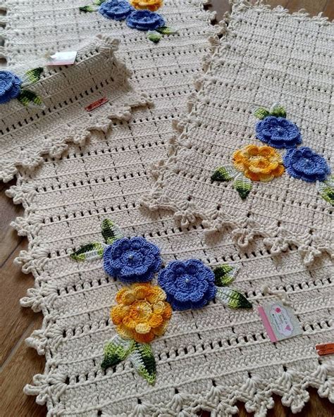 Two Crocheted Tablecloths With Flowers On Them