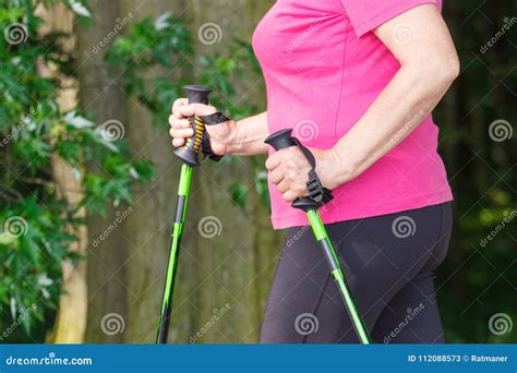 Hand Of Elderly Senior Woman With Nordic Walking Sticks Sporty
