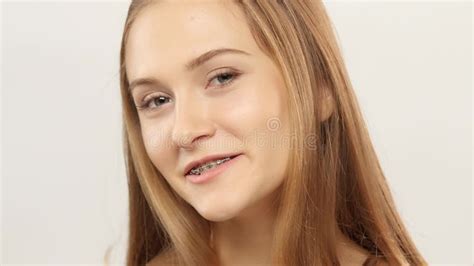 Young Girl With Braces On Teeth Looking At Camera And Smiling White