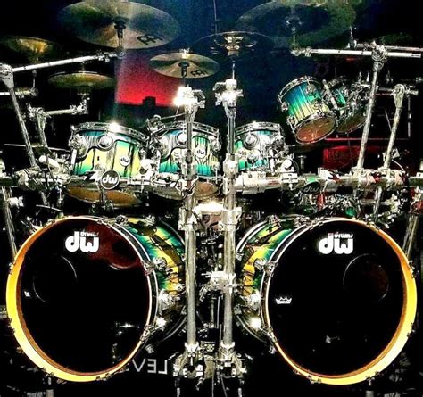A Drum Kit With Green And Yellow Designs On Its Drumsticks Sitting In