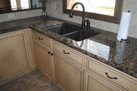 Granite Sandstone Countertop With Tan Cabinet Kitchen Design Ideas