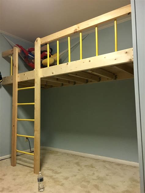 There Is A Bunk Bed With A Ladder On The Bottom And Yellow Rails Above It
