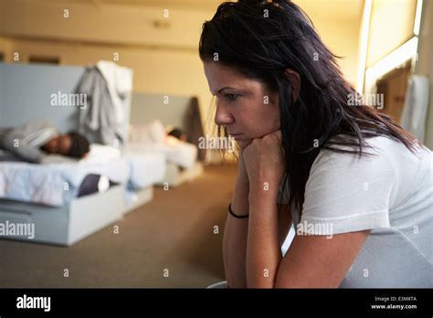 Women Sitting On Beds In Homeless Shelter Stock Photo Alamy