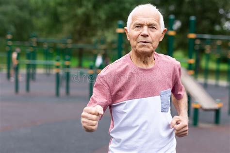 Old Man Running Beside Playground In Urban Park Stock Image Image Of