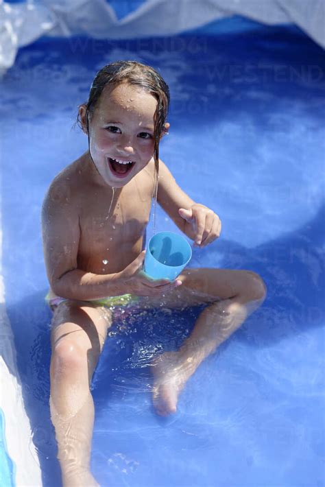 The material warms up the water quickly and it stays warm for the rest of the day in the. Little girl splashing with water in a paddling pool ...