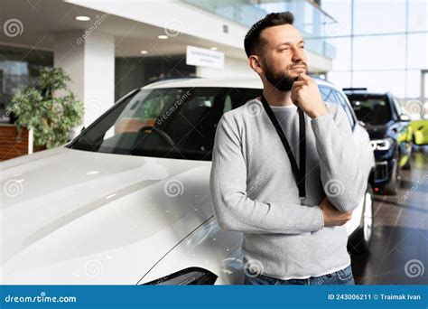 Car Sales Manager At Car Dealership Looking Ahead Thoughtfully Stock