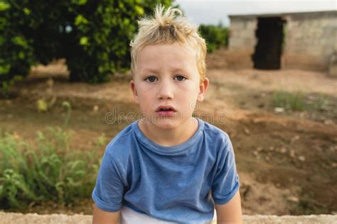 Blond Boy Making Funny Gestures And Faces Photographed From Above With