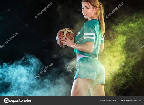 Portrait Of A Beautiful And Sexy Woman With A Basketball In Studio