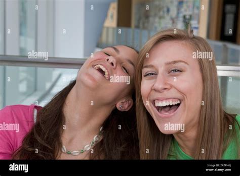 Two Teenage Girls Laughing Together One Looking At The Camera Stock