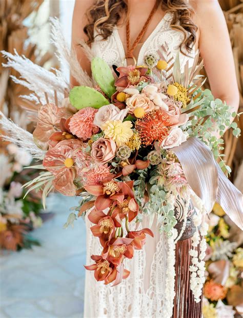 Made with silk roses in ivory, soft pink/peach and marsala/burgundy and greenery, finished with a burlap and lace wrap. Our Favorite 2020 Bridal Bouquets in 2021 | Desert wedding ...