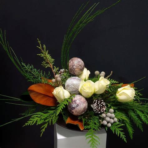 A Winter Arrangement Designed With Roses Silver Brunia Berries
