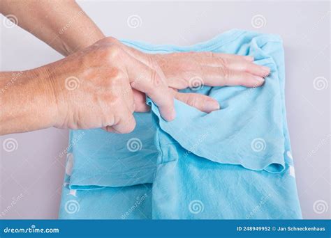 Close Up Of Womans Hands Folding A T Shirt Stock Photo Image Of