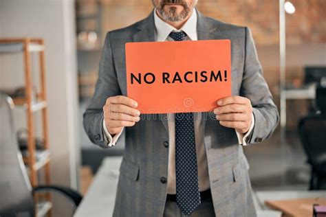 Man In Suit Holding No Racism Placard Stock Photo Image Of Poster