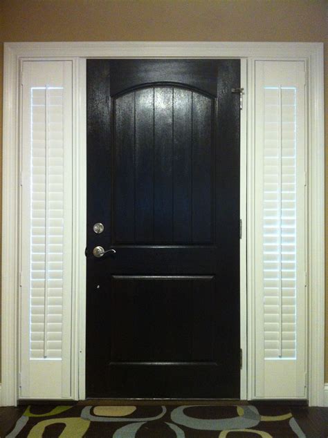 This traditional color often seems formal, but you can add a playful tone with a modern black door against. Black front door with shutters on side lights | outside ...