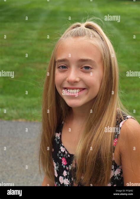 Cute Smiling 10 Year Old Girl With Long Hair And Print Dress Stock