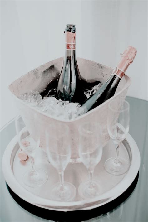 Two Champagne Flutes Are In An Ice Bucket