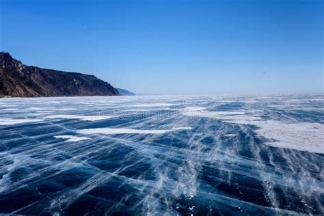 Frozen Lake Baikal Beautiful Mountain Near The Ice Surface On A Frosty