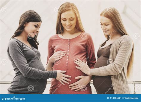 Two Cheerful Women Touching Their Pregnant Friend Stock Image Image Of Group Holding