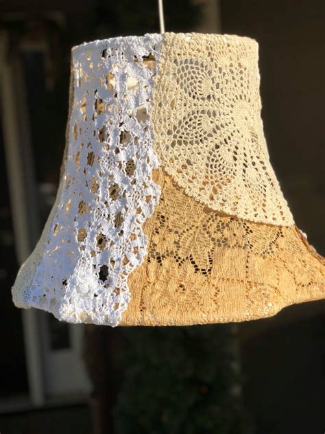 A Crocheted Lamp Shade Hanging From A Hook