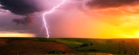 2560x1024 Thunderstorm Lightning Bolt Striking Down At Sunset In