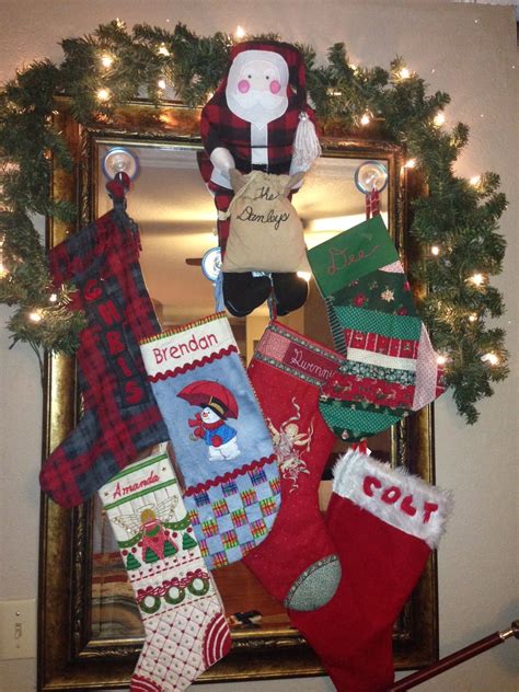 Before hanging the garland, string lights around the boughs to create a lighted focal point on the stairs. Found a way to hang Christmas stockings without a mantle ...