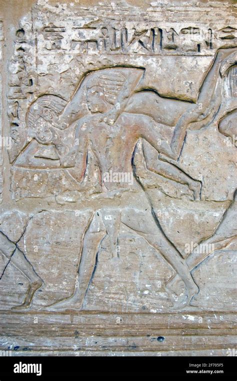 An Ancient Carving Showing Two Men Wrestling In A Form Of Judo This