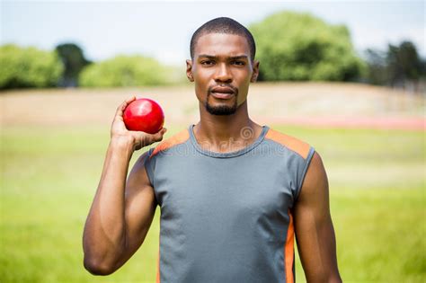 Although you need strength to throw a shot put, technique and form are much more important than muscle definition. Male Athlete Holding Shot Put Ball Stock Photo - Image of ...
