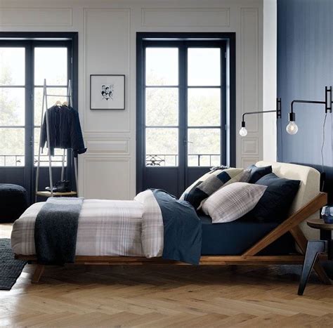 Wall sconces are taking bedside lights by storm! CB2 bed | Black wall sconce, Cb2 bedroom, Sconces living room