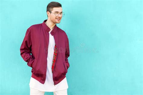 Fashion Hipster Guy In Glasses Poses Near The Wall The Color Of Stock Image Image Of Hipster