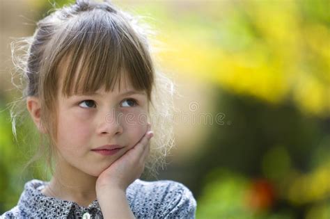 Portrait Of Thoughtful Pretty Young Woman Relaxing Outdoors On Warm Spring Sunny Day Stock Image