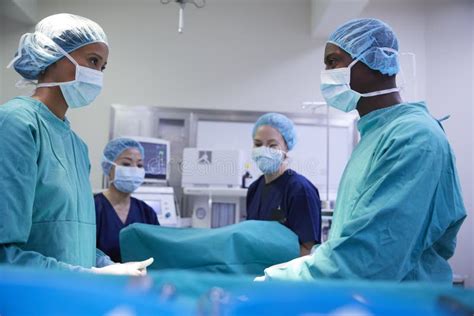 Surgical Team Working On Patient In Hospital Operating Theatre Stock