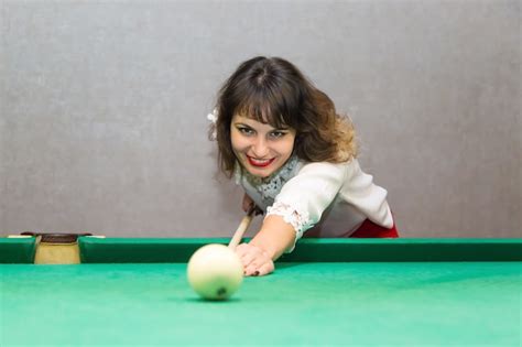 Premium Photo Brunette Woman Plays Billiards