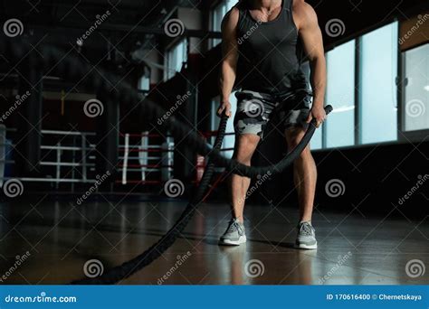 Man Working Out With Battle Ropes In Modern Gym Stock Photo Image Of