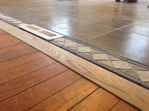 Wood floor living room tile kitchen. Threshold tile to wood floor in open concept living room ...