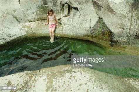 Girl Dipping Feet Into Stream Photo Getty Images